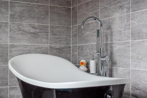 a bathroom with a sink and a faucet at Dales Edge - Skipton in Skipton