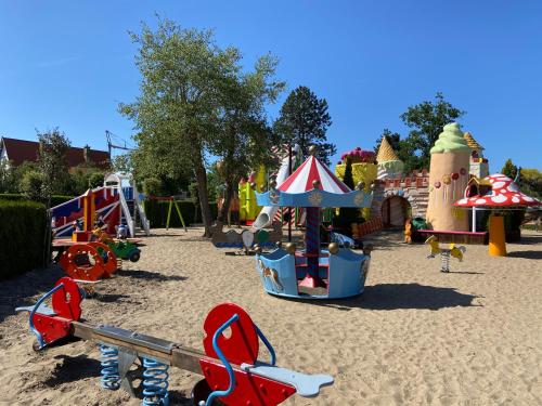 a playground with a play equipment in the sand at Marie Siska Boutique hotel in Knokke-Heist