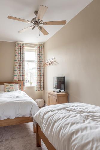 a bedroom with a bed and a ceiling fan at Dales Edge - Skipton in Skipton