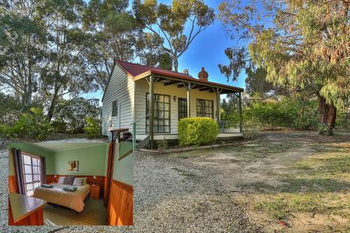 a small yellow and green house in a yard at Mountain View Motor Inn & Holiday Lodges in Halls Gap
