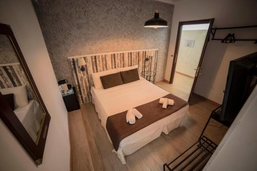 a bedroom with a bed with two towels on it at Galleria Frascati Rooms and Apartment in Frascati