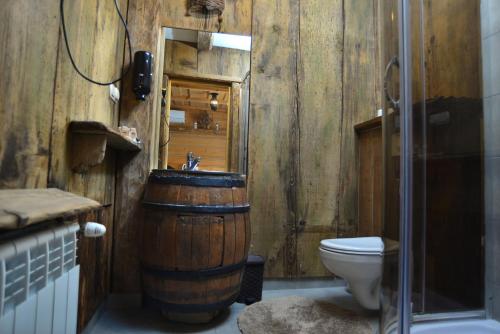 a wooden bathroom with a sink and a toilet at Gorący Potok Apartamenty in Szaflary