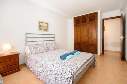 a bedroom with a bed with two blue pillows at Mirador del Roque in Órzola