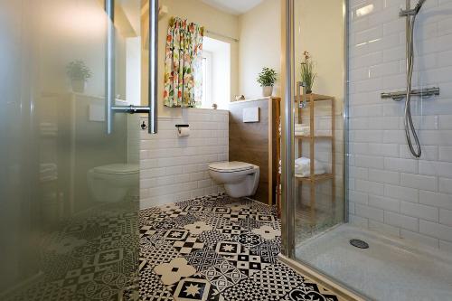 a bathroom with a toilet and a glass shower at B&B Destiny in Maldegem