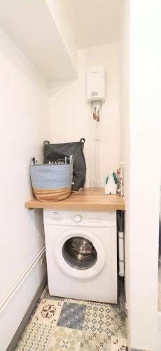 a white washing machine in a room with a counter at Le Tijo in Saint-Joseph
