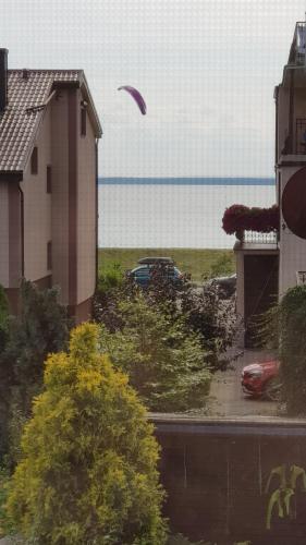 a kite flying in the sky over a house at Villa Baltic Chałupy - Apartament nr 1 in Chałupy