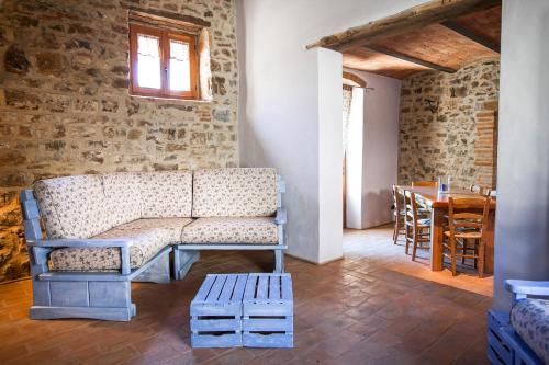 a living room with a couch and a table at Fattoria Le Fonti in Poggibonsi