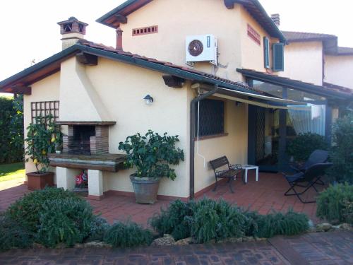 a house with a brick patio with a fireplace at Casa Daniela in Pietrasanta