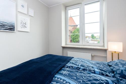 Posteľ alebo postele v izbe v ubytovaní Riverside Apartment Targ Rybny