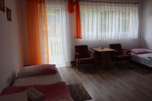 a room with a bed and a table and a window at Osrodek Wypoczynkowy " BIESZCZADY" in Myczkowce