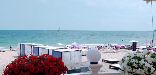 a beach with umbrellas and chairs and the ocean at Shalanda in Odesa