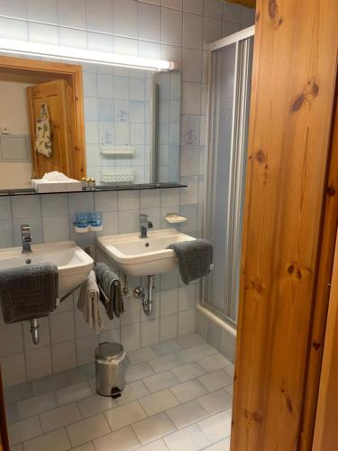 a bathroom with two sinks and a mirror at Ferienhaus am Burgsee in Ladis
