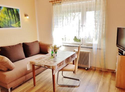 a living room with a couch and a table at Bungalow Krzyzaniak in Lohsa