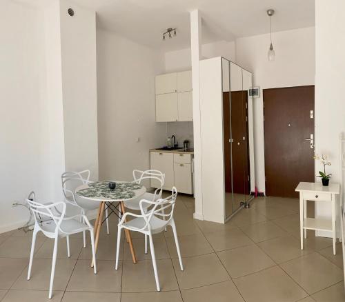 ミエンジズドロイェにあるApartament Villa Marea 22のキッチン付きの客室で、テーブルと椅子が備わります。