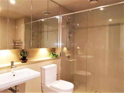 a bathroom with a shower and a toilet and a sink at Greenview in Sydney Olympic Park in Sydney
