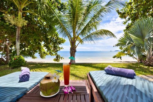a picnic table with a drink on the beach at Sea Valley Resort in Lipa Noi