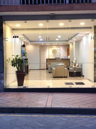 a large glass window of a living room at Hotel Santa Monica in Cuenca