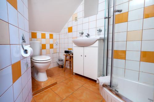 a bathroom with a toilet and a sink at Penzion U Kostela in Mikulčice