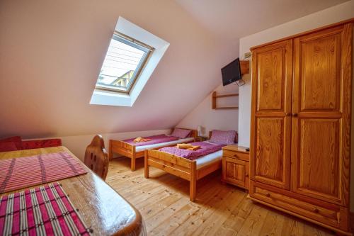 a small room with two beds and a window at Penzion U Kostela in Mikulčice