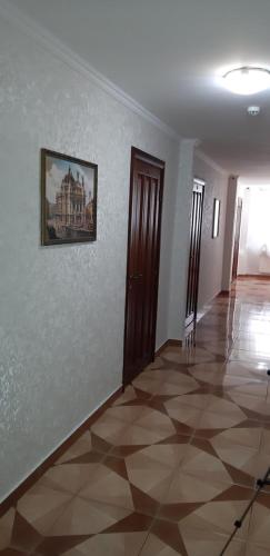 a room with a painting on the wall and a tile floor at Ідилія in Zhensna Polʼska