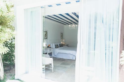 a bedroom with a bed and a bedroom with a window at Villa Raphael in Búzios