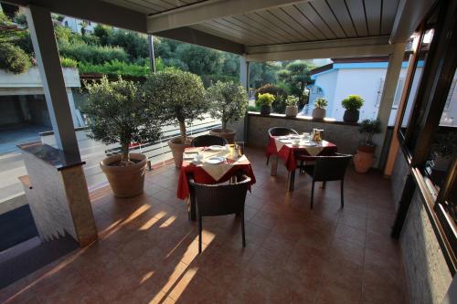a restaurant with tables and chairs on a balcony at Pension Silvia in Portorož