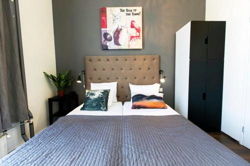 a bedroom with a bed with two pillows on it at Quentin England Hotel in Amsterdam