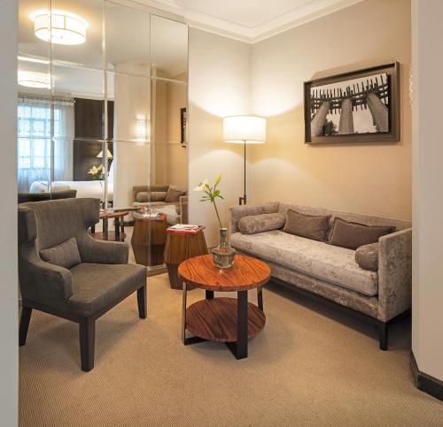 a living room with a couch and a table at Hippodrome Hotel Condesa in Mexico City
