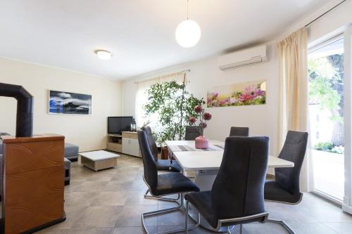 a living room with a dining room table and chairs at Apartment Carmen in Pula