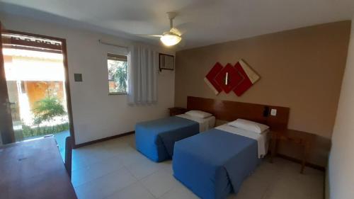 Katil atau katil-katil dalam bilik di Palmier Hotel & Convenções
