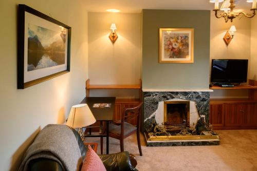 a living room with a fireplace and a tv at The Rocks in Westport