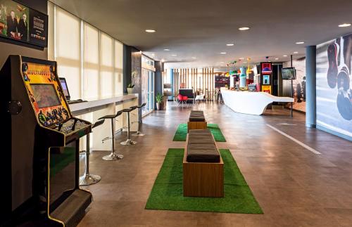 a lobby with a row of benches in a store at ibis Sao Paulo Interlagos in Sao Paulo
