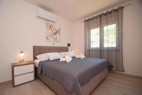 Postel nebo postele na pokoji v ubytování VILLA APARTMENTS FILIP