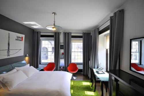Postel nebo postele na pokoji v ubytování Swiss Hotel