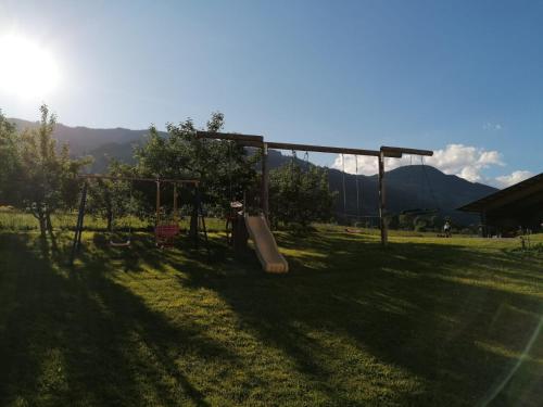a playground with a slide in a field at Ferienhaus Oberhuben in Fügenberg