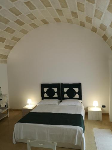 a bedroom with a large bed with two tables at B&B Corte San Giuseppe in Casarano