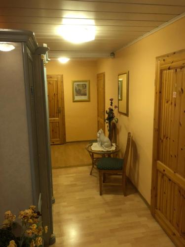 a hallway with a table and a chair and a room at Deutsches Haus in Neuhütte