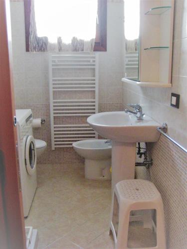 a bathroom with a sink and a toilet at RESORT VILLAGE AQUA MARINA FAMILY - Daily Rooms Tidying - CocktailsBar- Pet Friendly - with Hypermarket - Delivery Restaurant-Pizzeria - Room Breakfast with supplement - Ultra Fast Wi-Fi - Play Area for children - Olympic Swimming Pool - Parking in Caorle