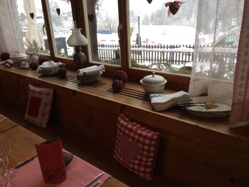 a window sill with a table and some dishes on it at Hotel Schöntal in Filisur