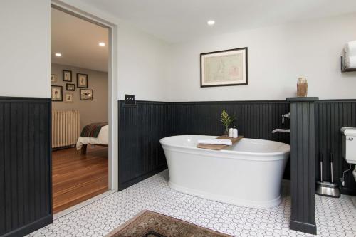 a bathroom with a bath tub in a room at Granville House in Great Barrington