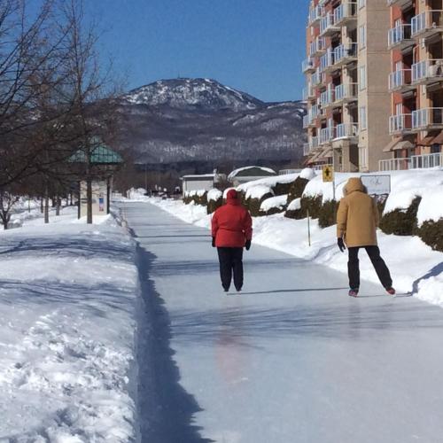 two people walking down a street in the snow at À Amour et Amitié in Magog-Orford