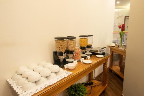 a table with bowls and other items on it at Golden Ingá Hotel in Maringá