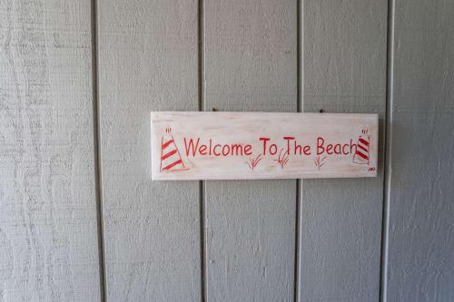 a welcome to the beach sign on a wall at Ocean Front on Harbor Island in Oceanmarsh Subdivision