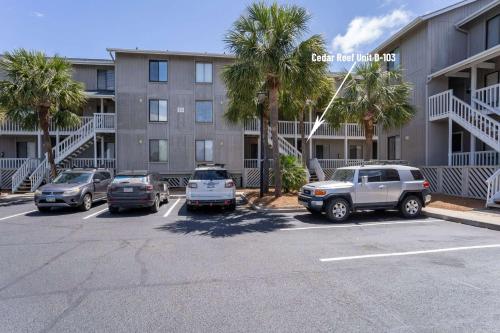 a parking lot in front of a building with palm trees at Ocean Front on Harbor Island in Oceanmarsh Subdivision