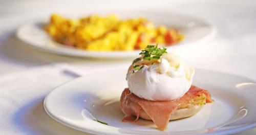 a white plate with a dessert on a table at Grande Hotel do Porto in Porto