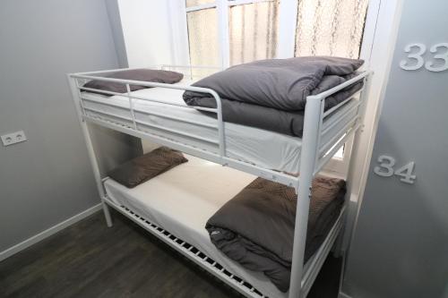 a room with three bunk beds with pillows on them at Madrid Downtown Hostel in Madrid