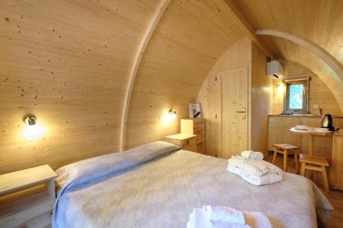 a bedroom with a bed in a wooden room at Castello di Marano sul Panaro - Room & Breakfast in Marano sul Panaro