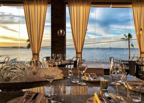 a dining room with a view of the ocean at Posada de las Flores La Paz in La Paz