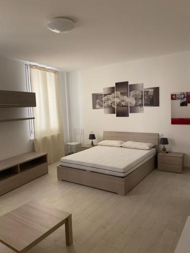 a bedroom with a bed and pictures on the wall at senza pensieri via 4 novembre/via diaz in Crema