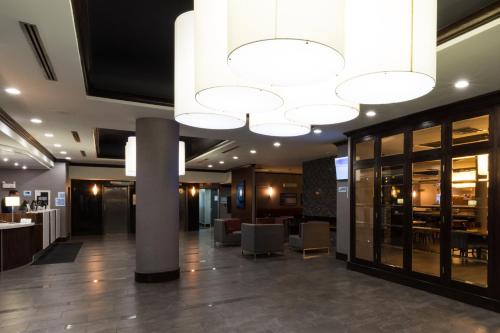 a lobby of a hotel with a large chandelier at Holiday Inn Express Edmonton Downtown by IHG in Edmonton